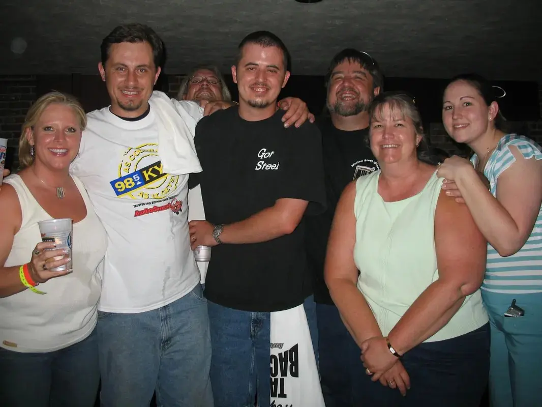 A group of people posing for a picture in a bar.