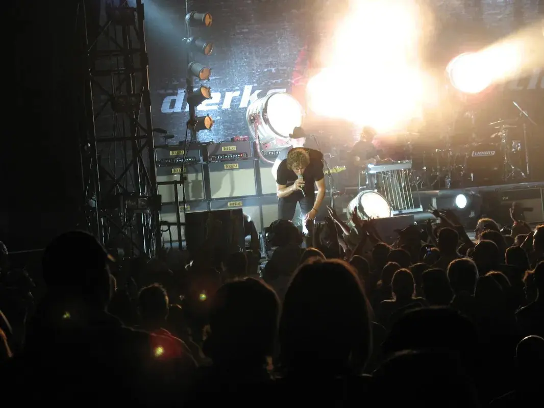 A group of people on stage at a concert.